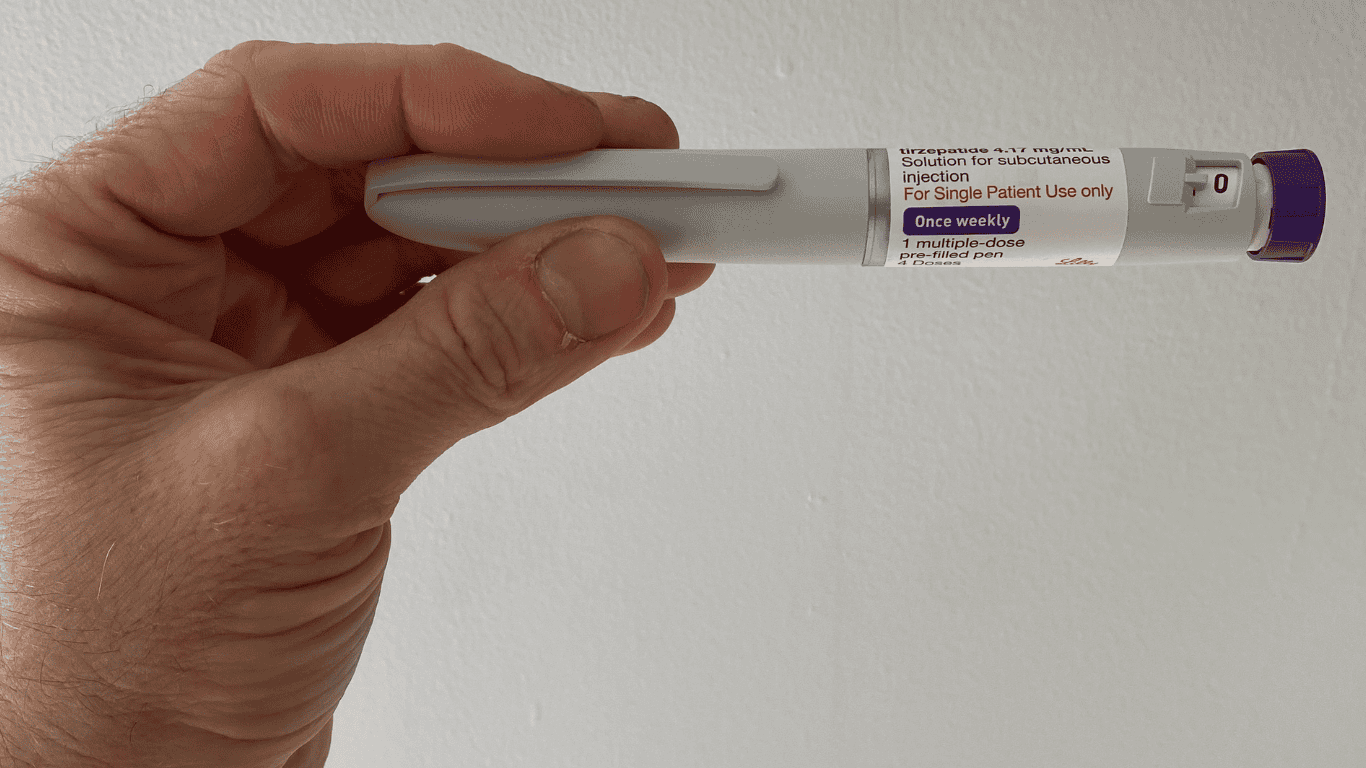 GLP-1 weekly injection pen (tirzepatide) held in hand