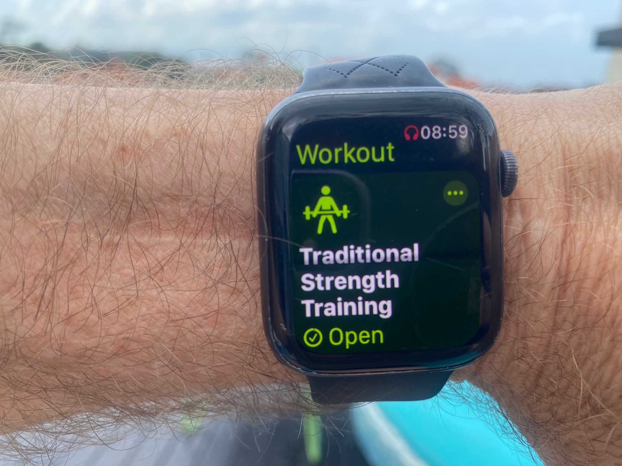 Apple Watch on a wrist showing the Traditional Strength Training workout screen.