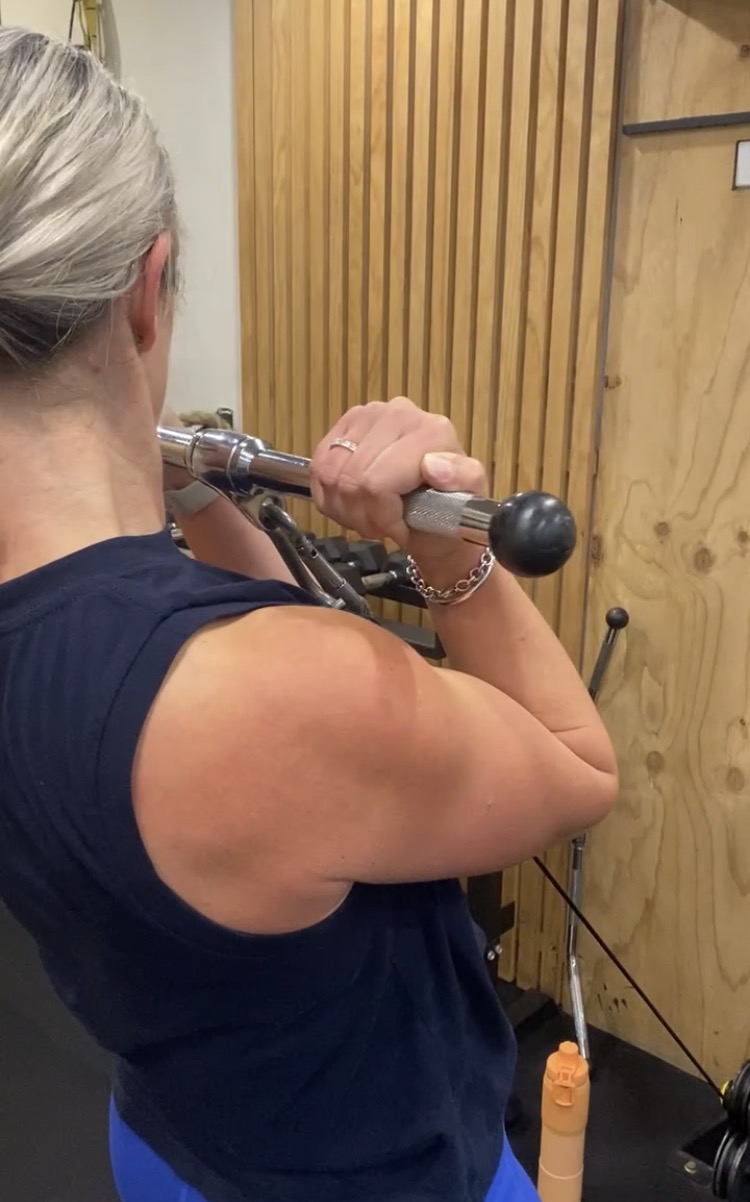 Client doing a cable arm exercise at The Fitness Space studio in Maroubra.