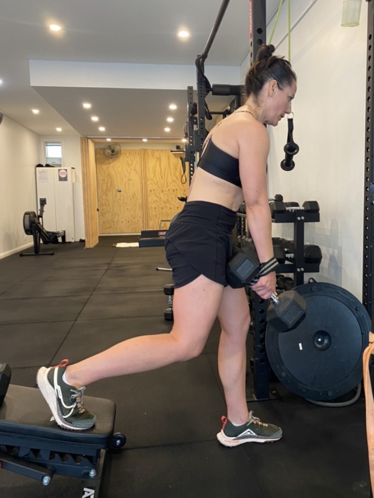 Functional strength after 50: single-leg split squat at The Fitness Space, Maroubra Client doing a single-leg dumbbell split squat at The Fitness Space studio in Maroubra
