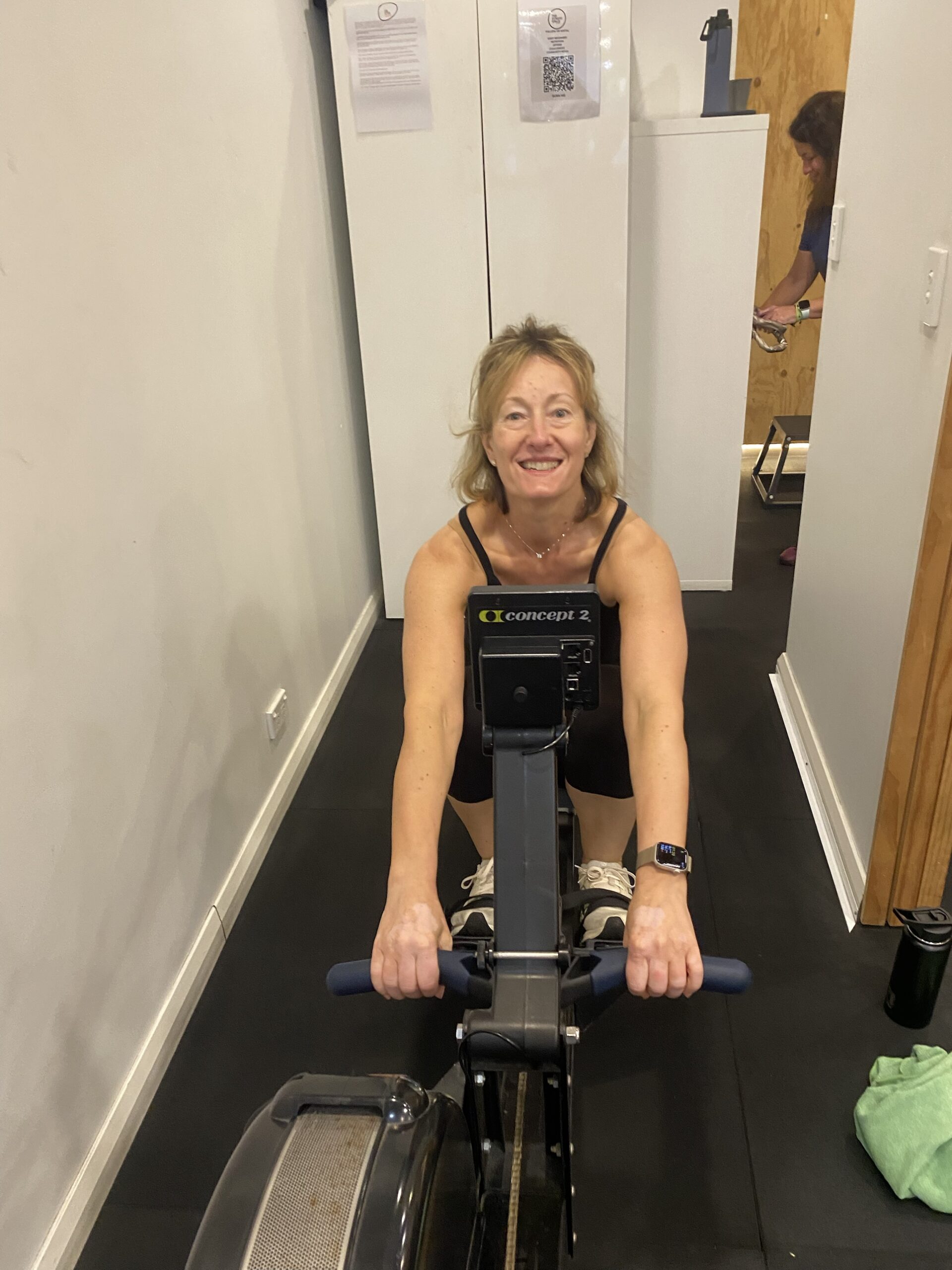 Menopause and exercise: client on the rowing machine at The Fitness Space, Maroubra Client smiling on the rowing machine at The Fitness Space studio in Maroubra
