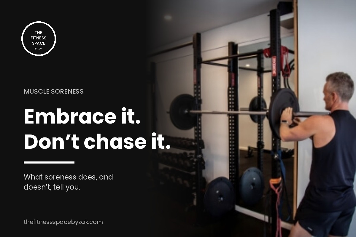 Man loading a barbell on a squat rack at The Fitness Space Maroubra, with the words Embrace it, don't chase it
